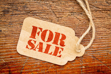for sale sign on a price tag that is laying on a wood table